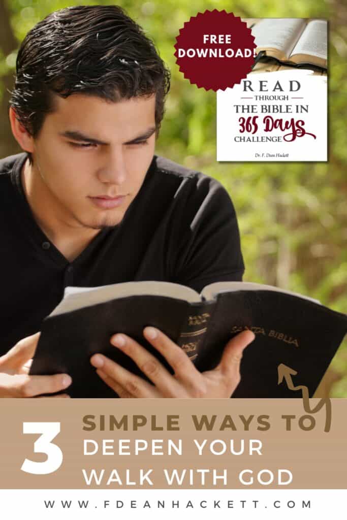 Man sitting in field reading Bible