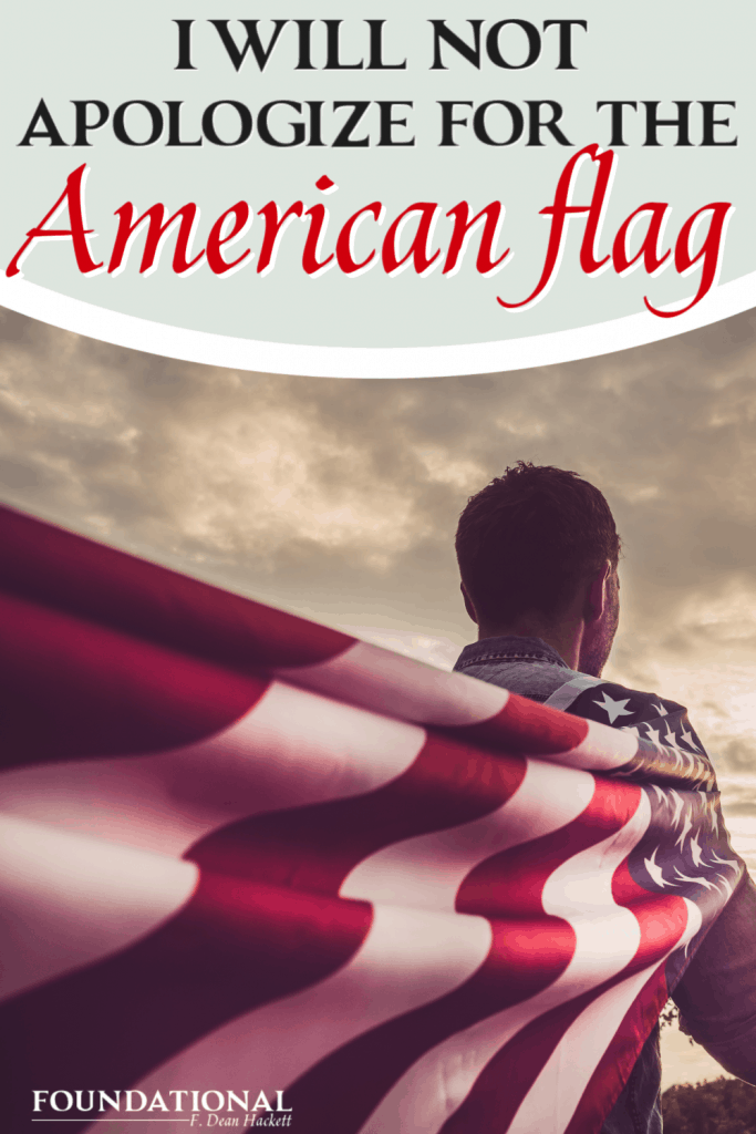 Man holding American flag over shoulder