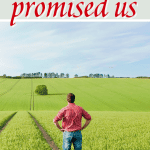 man standing in large field looking out with hands on hips