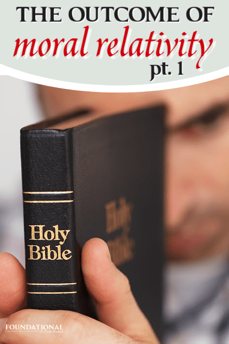 man holding a Bible up to his face with spine pointed out