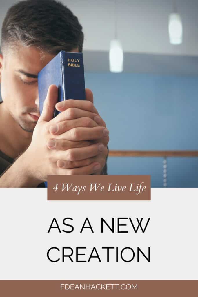 Man holding a Bible to his forehead as he prays