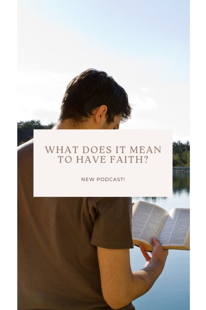 Man standing in front of lake reading the Bible