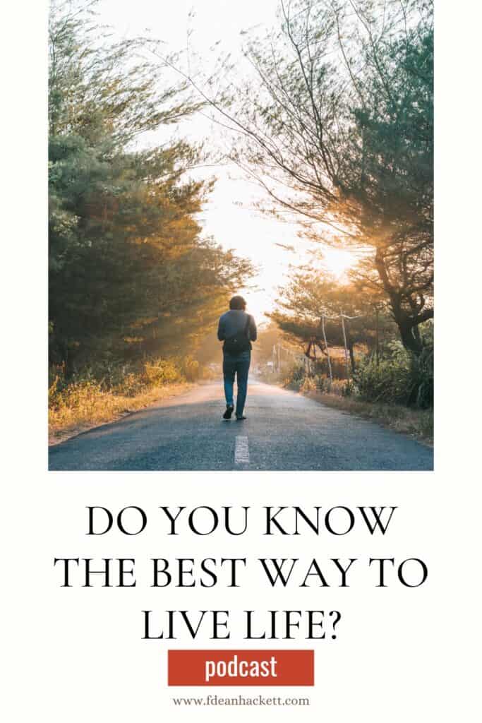 Man walking down a road lined with trees