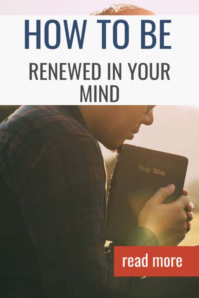 Man holding a Bible resting on his chin