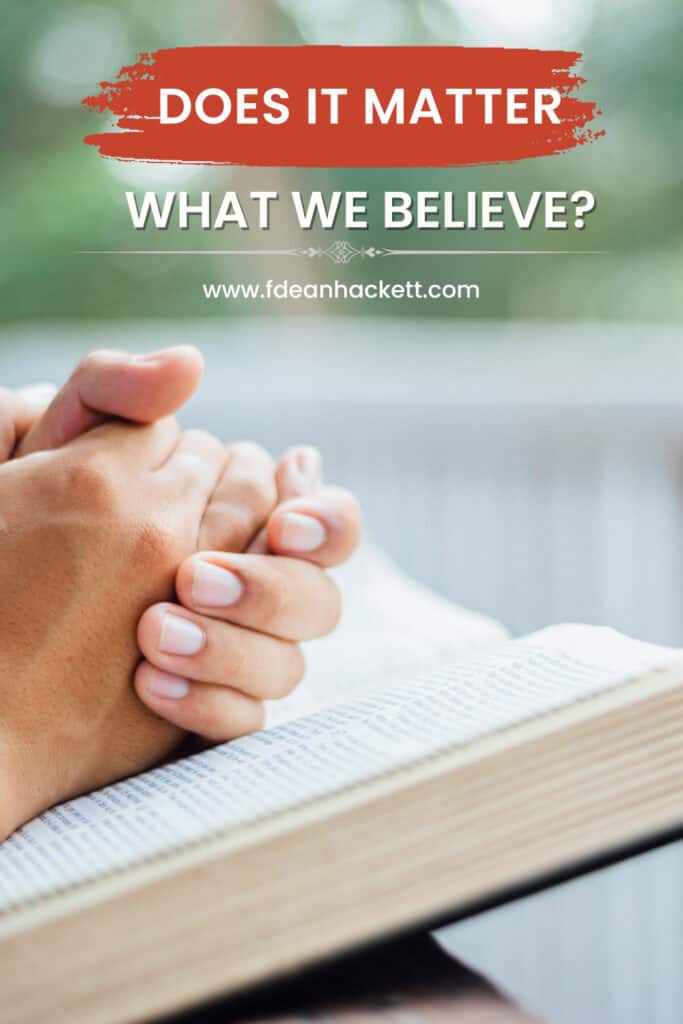 persons hands folded on a Bible