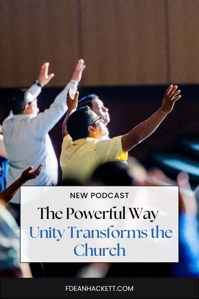 people in a church raising hands worshiping