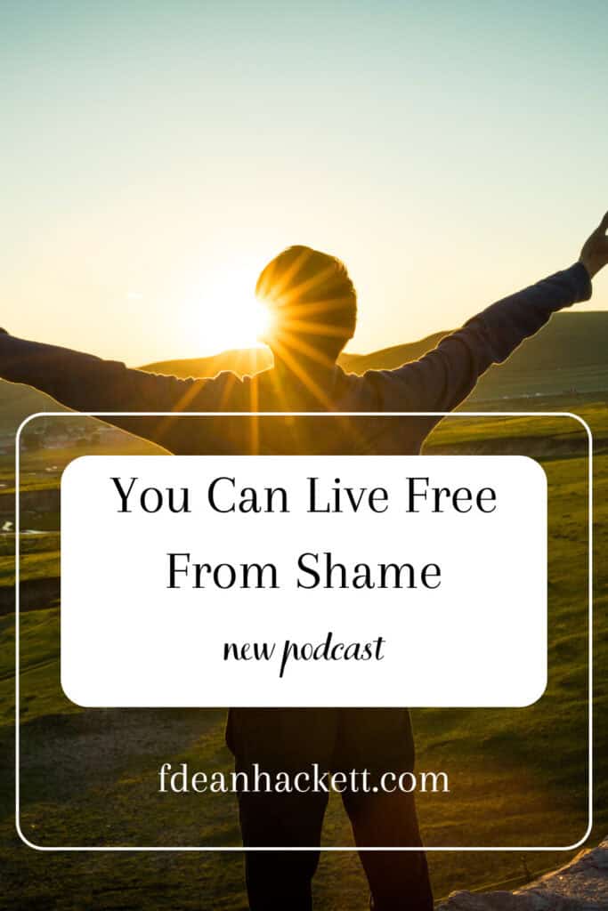 Man facing sun with arms outstretched