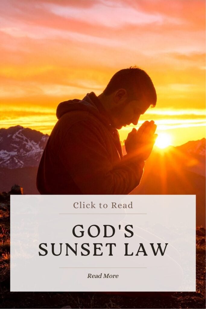 Man praying in front of a sunset, meditating on God's Sunset Law
